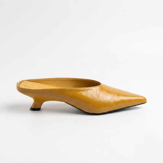 Yellow pointed-toe shoe on a white background