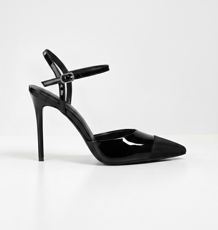 Black high-heeled shoe with a strap on a white background